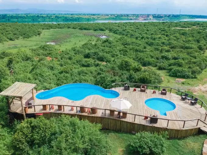 Uganda lodge pool deck surrounded by green landscape