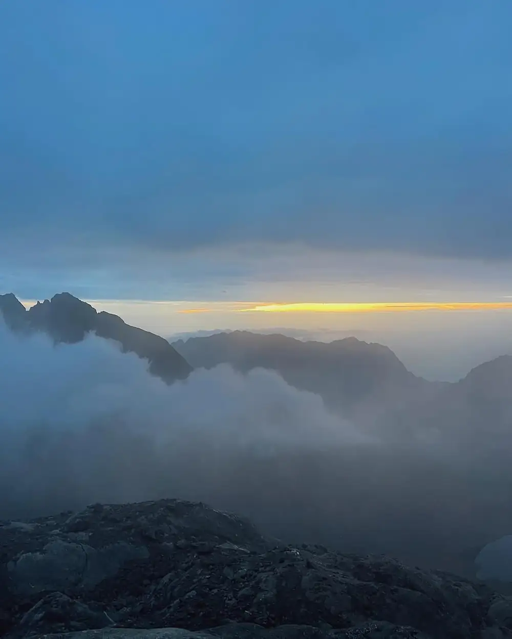Sunrise above misty Rwenzori mountain ridges
