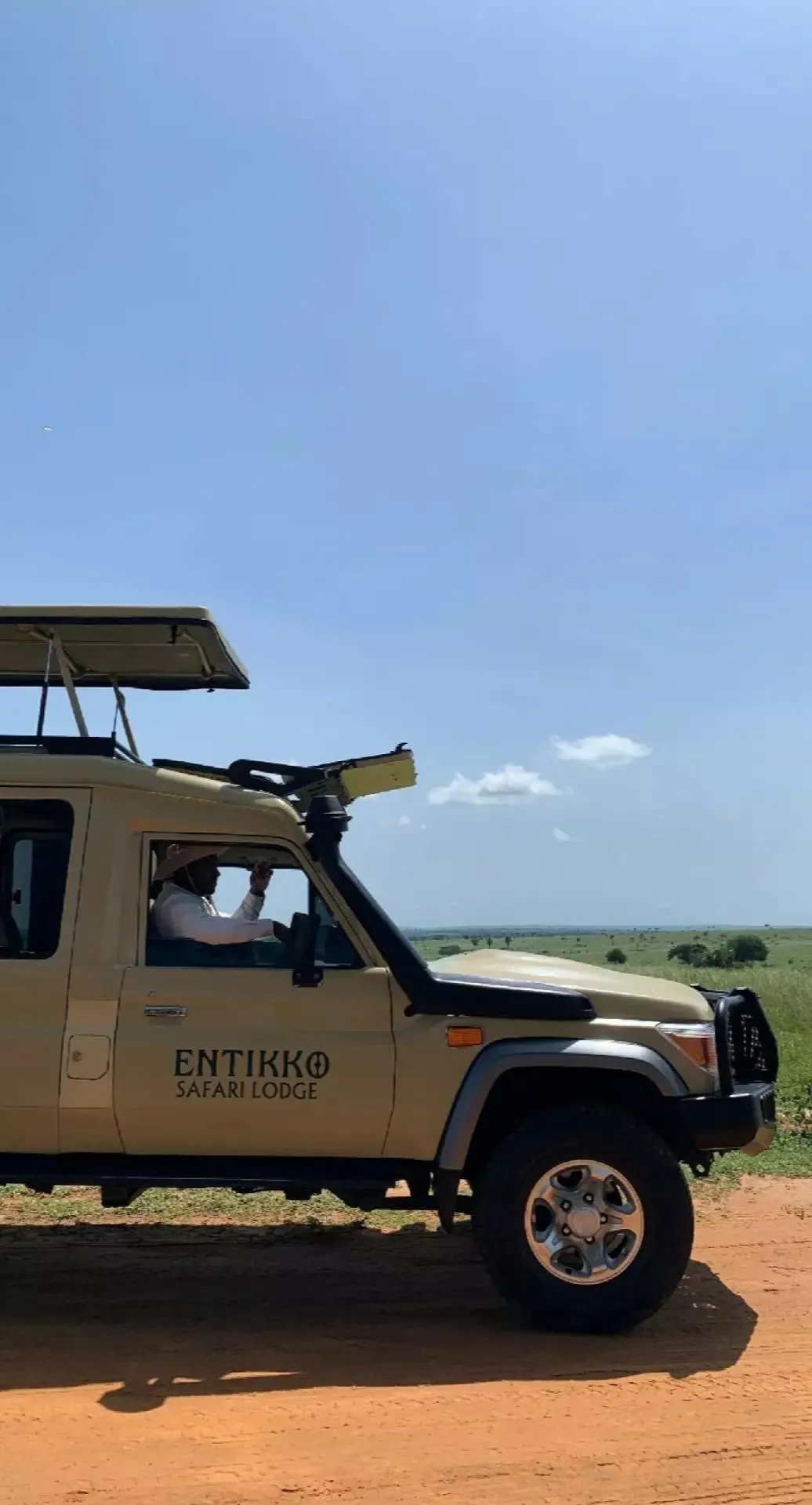 Safari vehicle on open Uganda plains