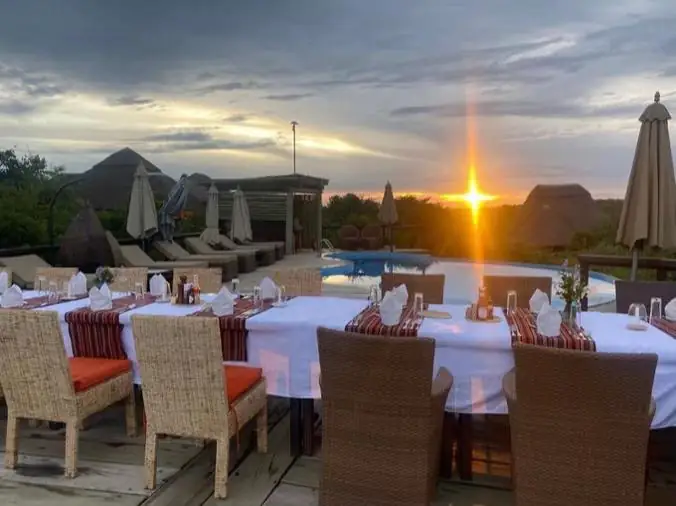 Outdoor lodge dining terrace at sunset