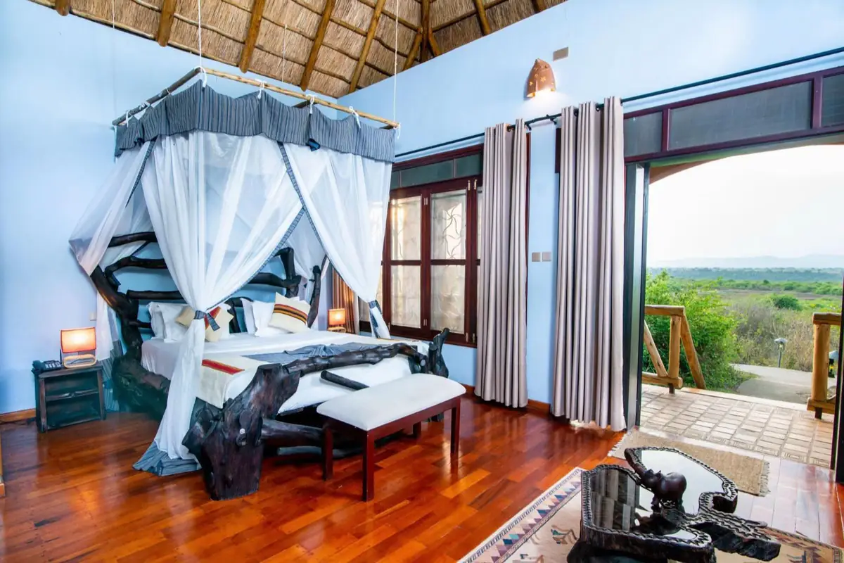 Comfortable Uganda lodge suite with mosquito net and balcony view